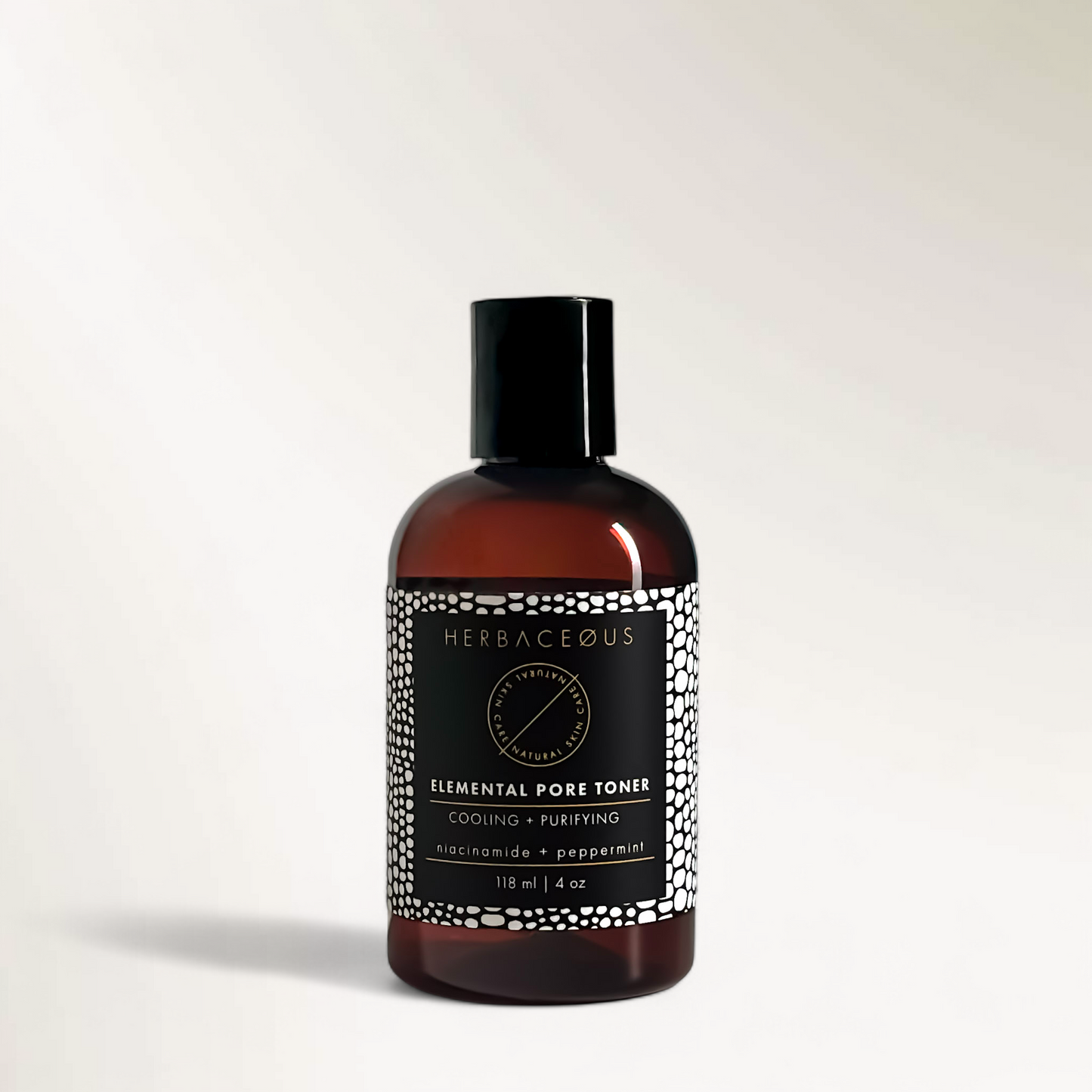 Bottle of Herbaceous Elemental Pore Toner on a light gray background