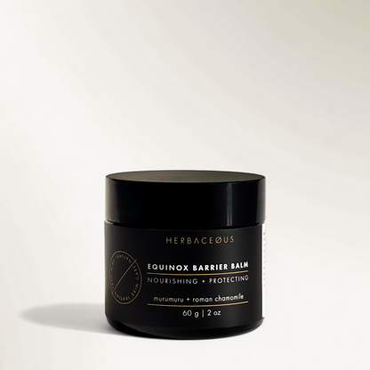 Black jar of Herbaceous Equinox Barrier Balm on a light gray background