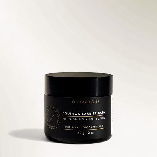 Black jar of Herbaceous Equinox Barrier Balm on a light gray background