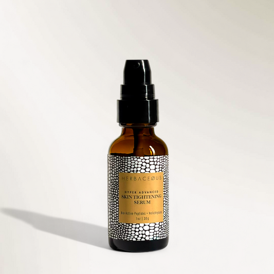 Brown glass serum bottle with black cap on a white background